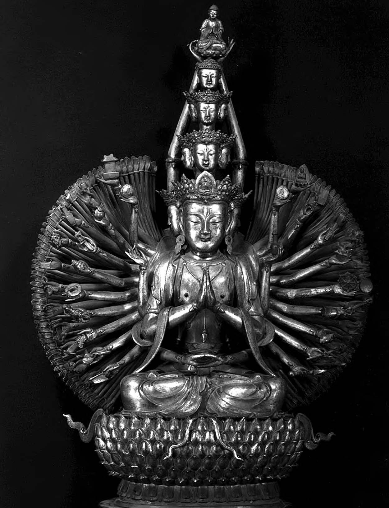 statue that has many arms on the figured of a seated body