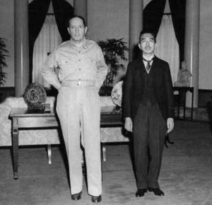 photo of two men in suits next to each other