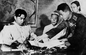 photo of men in military uniforms signing a document