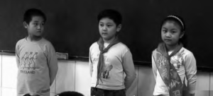 three young children stand together