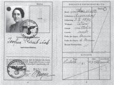 Photograph of Josefine Raubicek exit visa which includes an image of a middle aged Josefine along with her personal information and a German exit visa approval stamp. 