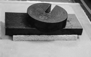 Drying handmade paper with a weighted sponge to determine how drying force affects paper thickness.