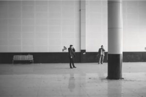 photo of two people standing in a large hall