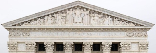 This is the picture of the East Pediment of the Supreme Court building. It has a triangle roof with a statue of many historical figures, including Confucius. Below is a line "JUSTICE THE GUARDIAN OF LIBERTY."