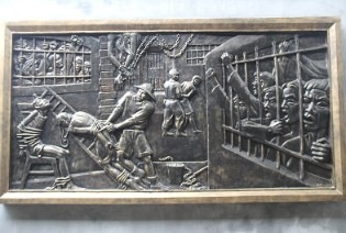 photo of a relief of people in prison
