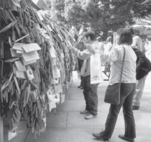 Students and parents posting votive tablets for educational success