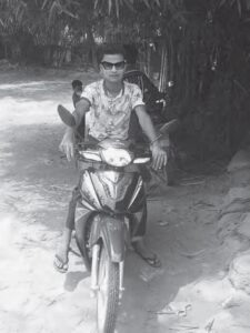 photo of a teenaged boy on a motorized bike
