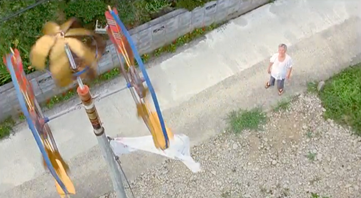  Tadashi’s grandfather and the family’s koinobori flagpole, flying the tenugui cloth that Tadashi won in place of the traditional koi carp streamer.