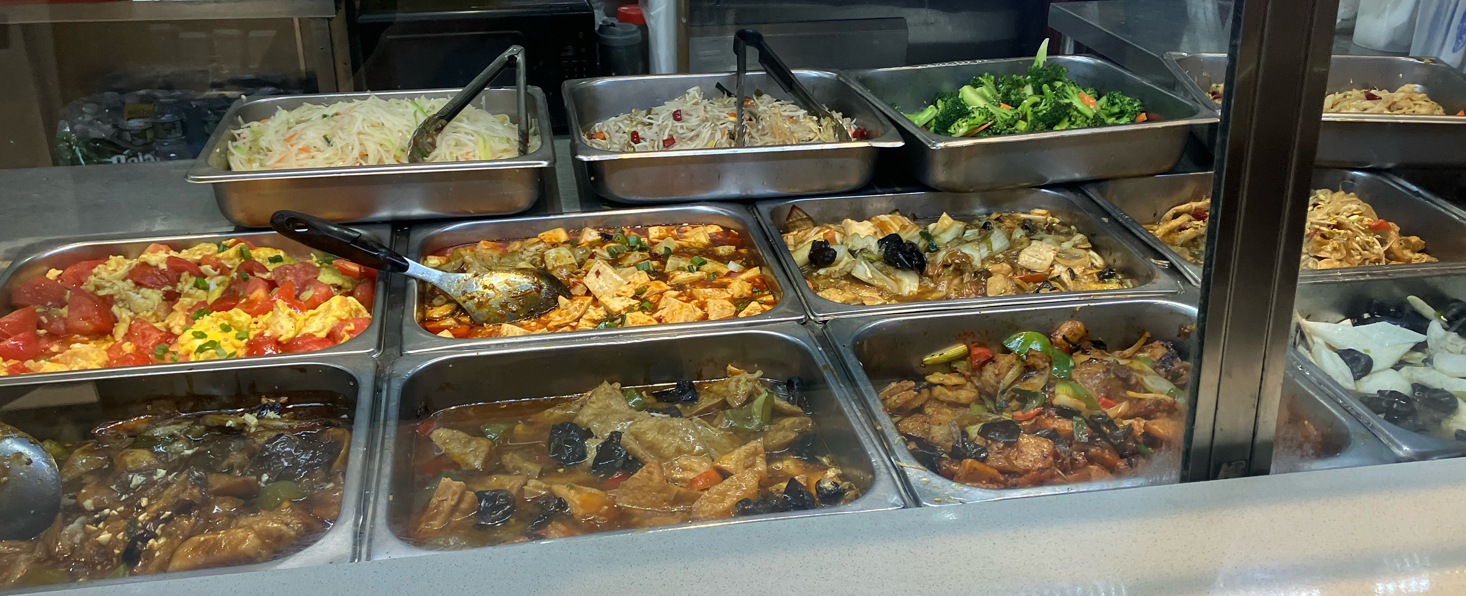  With the clatter of steam trays and takeout boxes, this Flushing lunch spot recreates the canteens of Chinese factory towns.