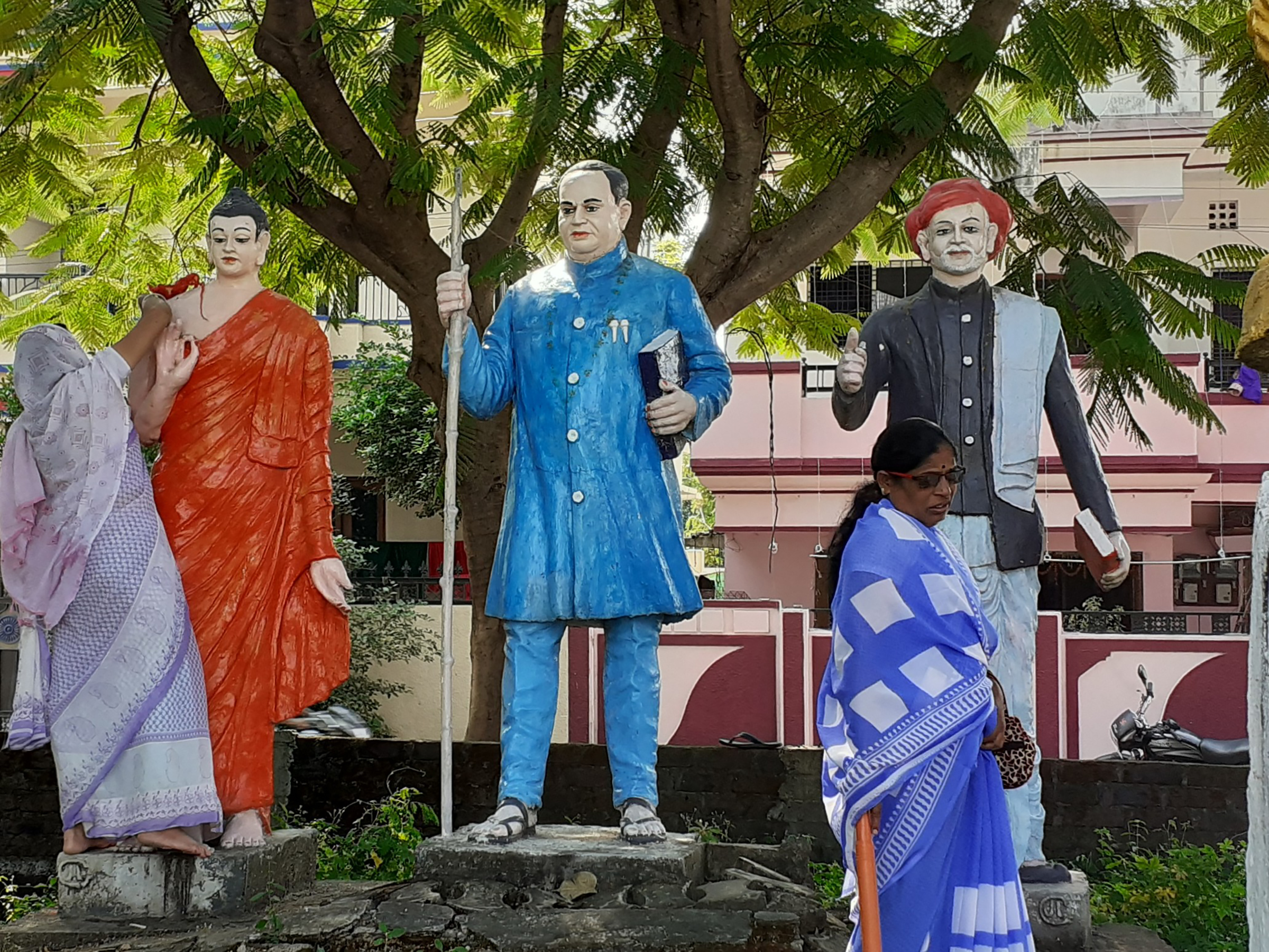 Women cleaning statues of Buddha, Dr. Ambedkar, and Mahātmā Phule at a Buddha vihar in Nagpur, Maharashtra state, India. November 12, 2019