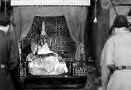 photo of a woman in hanbok on an elaborate seat