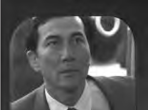 a man in a suit looks through a window