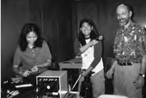 three people smile for a photo