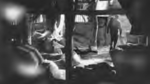 photo of a man walking out of a grain mill