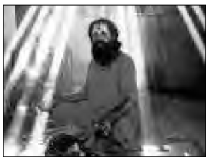 photo of a man meditating with sun rays beating down on him