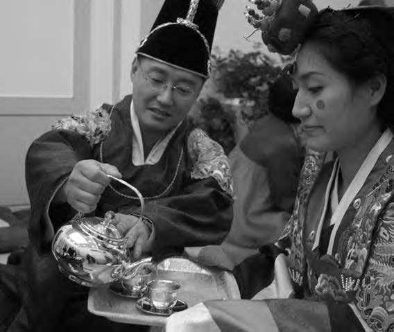 a man pours a woman tea