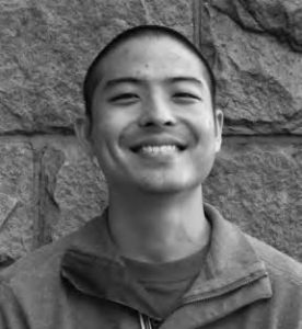 a man smiles broadly